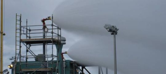 Industrial fire monitors spraying water streams from an elevated platform.